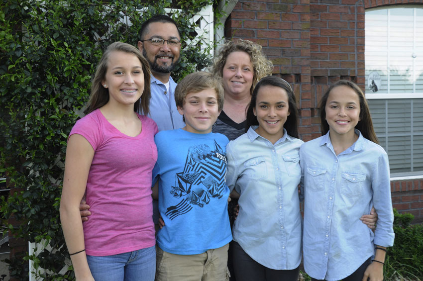 The Regulacion family today, pictured left to right: Issabella, Elijah, Hannah, and Madison, with their parents, Rey and Michelle, standing behind them.