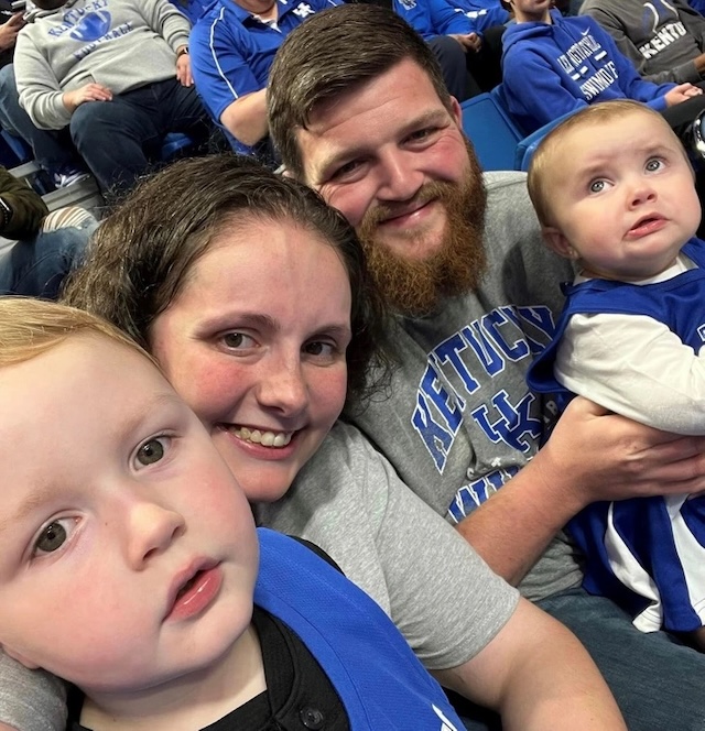 Michael and his family enjoying a Kentucky Wildcats game together, smiling and making memories that will last a lifetime