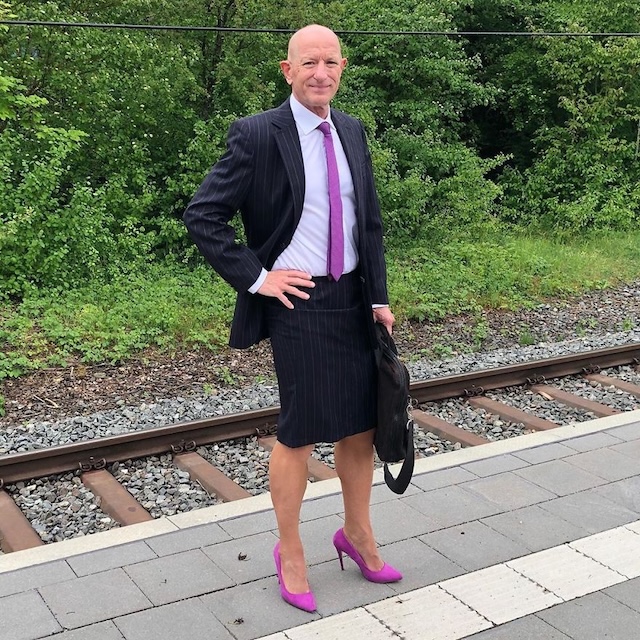 A bold fashion statement: Mark Bryan confidently wears a pinstriped suit and purple heels, showcasing his nonconformity