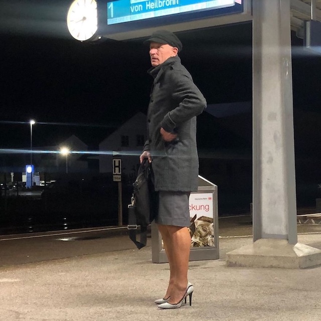 Braving the night in high heels and a smart coat at the station