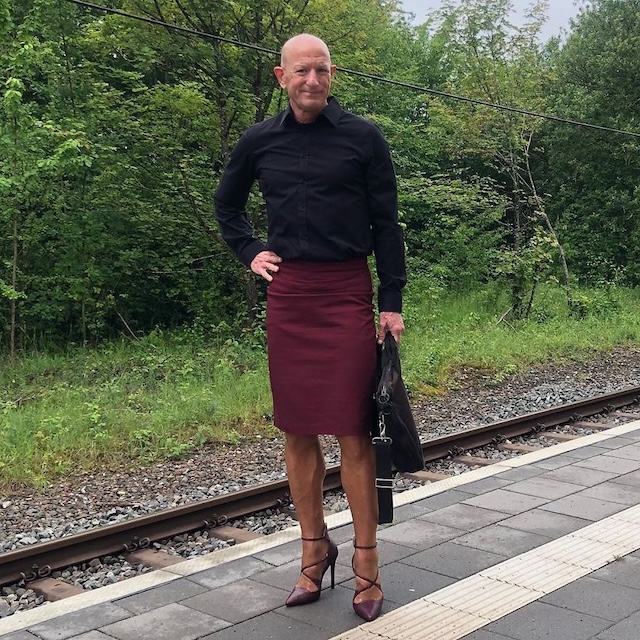 Commanding attention with a maroon skirt and black shirt, topped off with sharp heels at the station