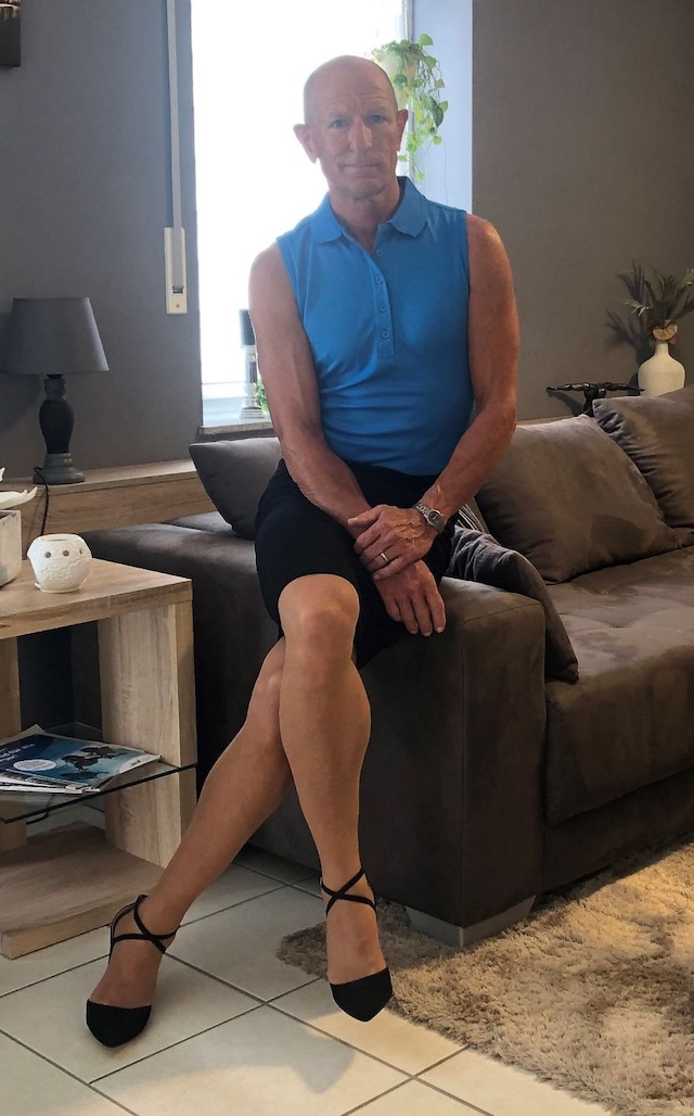 Striking a pose in black heels and a fitted shirt with a skirt, looking fabulous at home