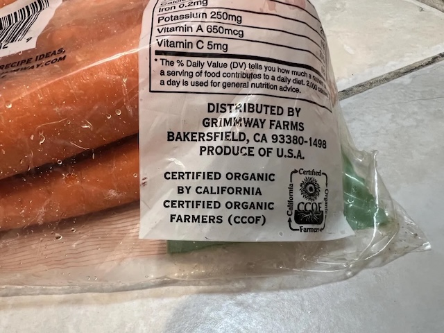 Packaging of the recalled organic carrots distributed by Grimmway Farms, highlighting certified organic labeling and distribution details