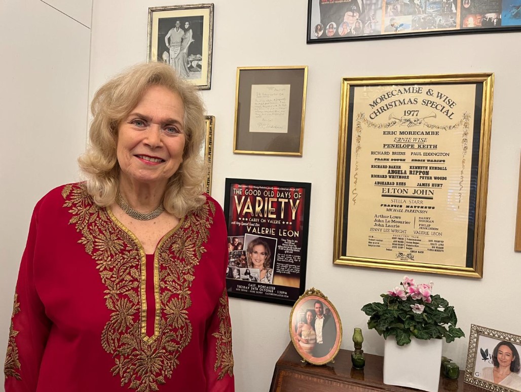 Valerie surrounded by cherished keepsakes from her career in her living room