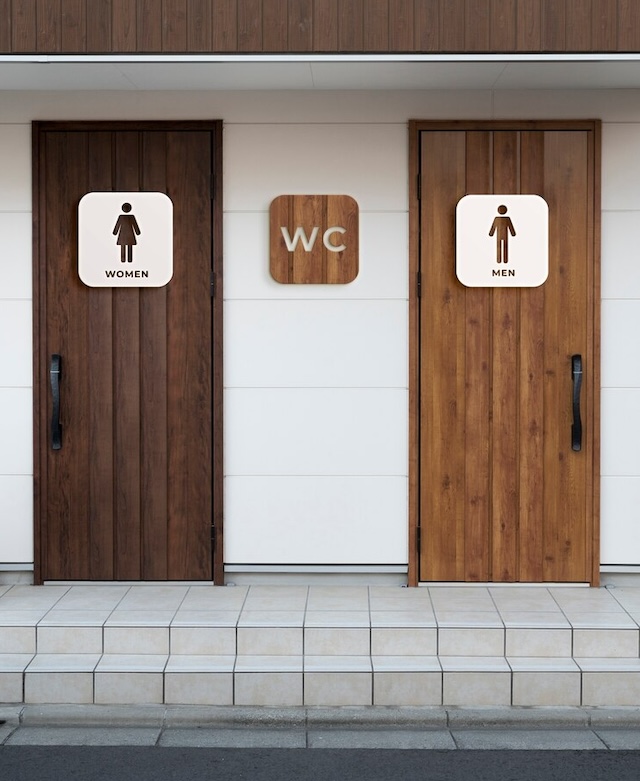 A modern take on the classic 'WC' sign, indicating restrooms for men and women