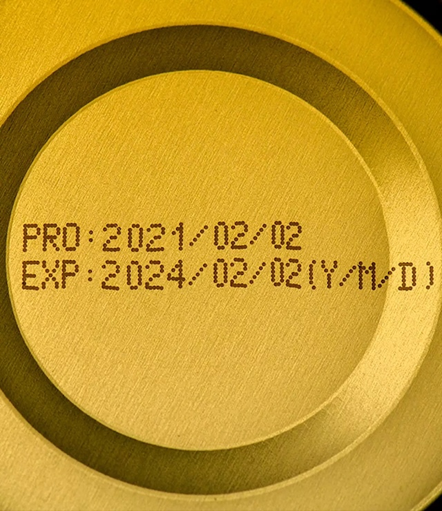 A can lid highlighting both production and expiration dates, revealing the complexity of food labeling