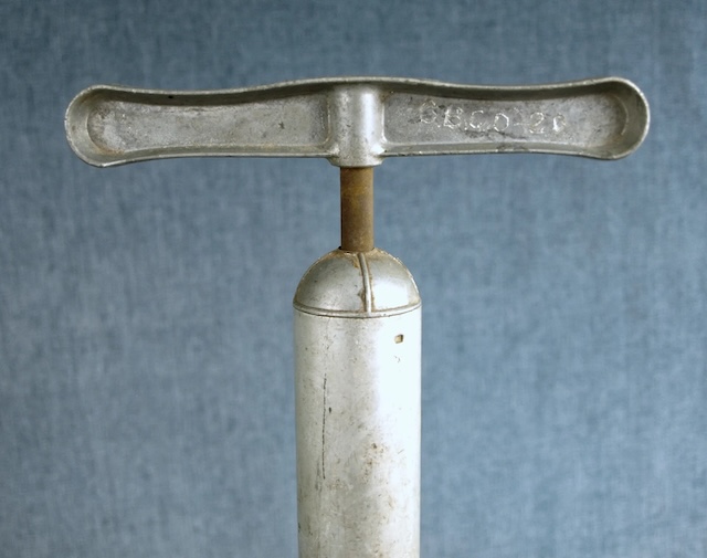 A closer look at the top part of the vintage bicycle pump, highlighting its mechanical design