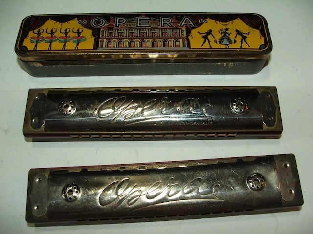 A trio of vintage harmonicas, each with its unique design, ready to create melodious tunes reminiscent of the past