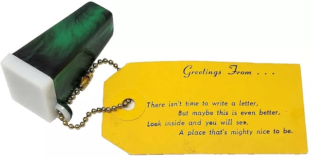 A green Vintage Delmar Colorscope picture viewer keychain with its original yellow tag, featuring a poetic message—"Greetings From..."—a classic souvenir item