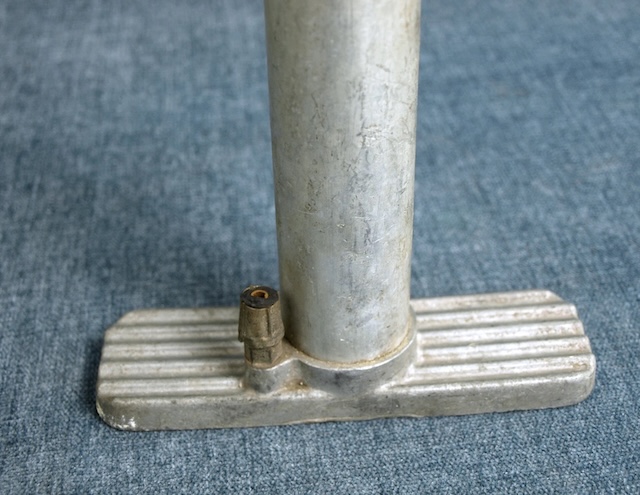 This image displays the sturdy, metal base of the vintage bicycle pump, built for durability and functionality