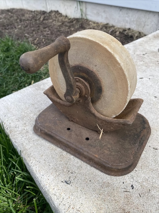 A once indispensable tool, the Antique Cast Iron Hand Grinder Sharpener Stone Wheel stands the test of time