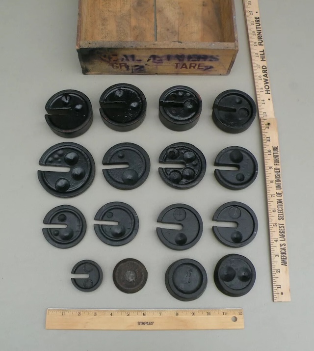 Preserved scale weights resting in their original wooden box, showcasing both utility and nostalgia