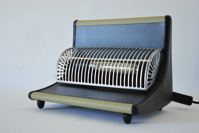 A detailed close-up of a vintage revo electric heater, emphasizing the unique construction and materials that made this household item both durable and reliable throughout its time