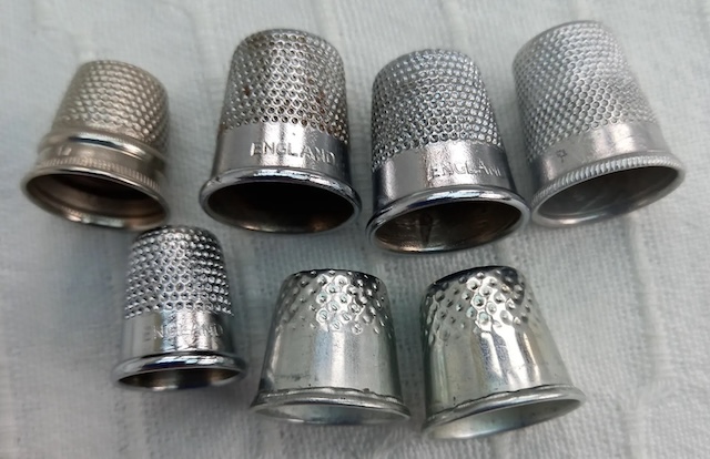 A close-up view of elegant silver vintage thimbles, showcasing their intricate detailing and craftsmanship