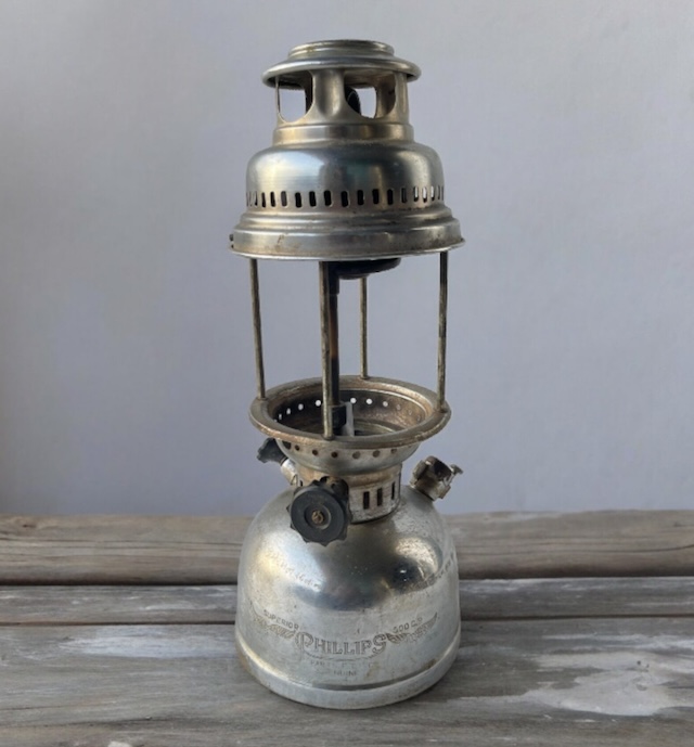 A beautifully preserved vintage kerosene pressure lantern by Phillips, displaying its intricate design and sturdy craftsmanship