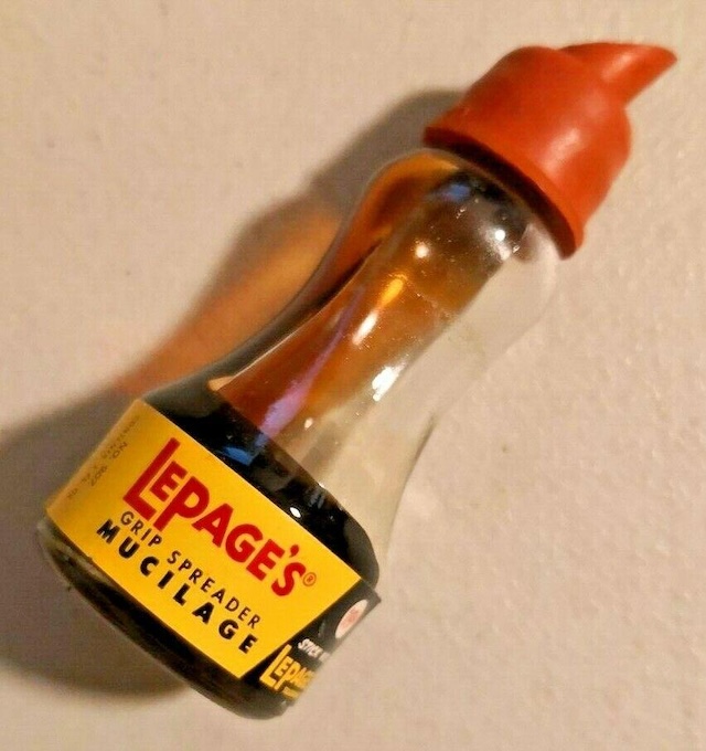 A close-up of the vintage Lepage's Mucilage Glue, showcasing the iconic spout cap design that made applying glue precise and easy