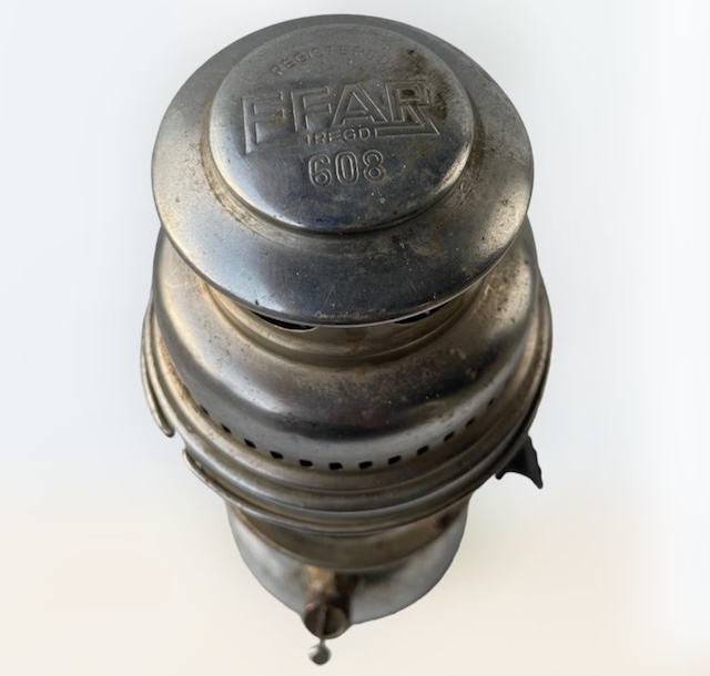 The top view of the vintage kerosene pressure lantern, with 'FEAR 608' embossed on the cap, hinting at its historic lineage and quality