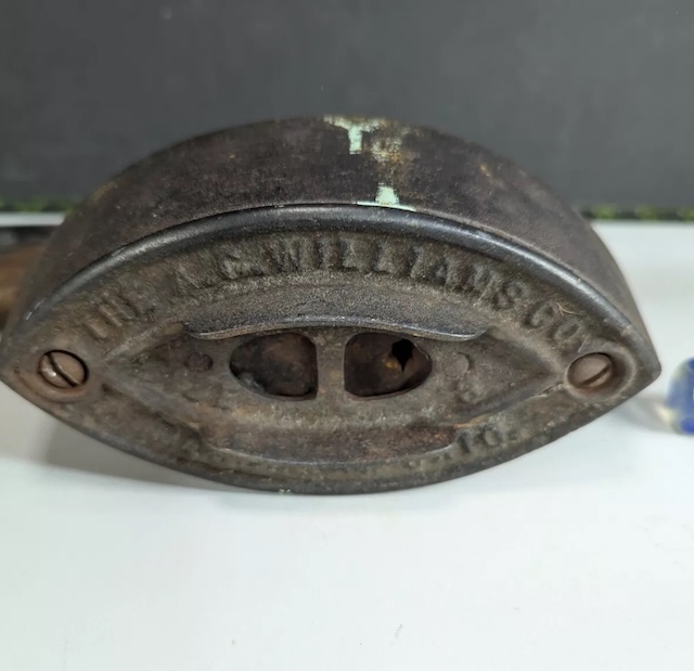 Here's a closer look at the inner workings of the vintage cast iron clothes iron, with its original, well-maintained parts still intact