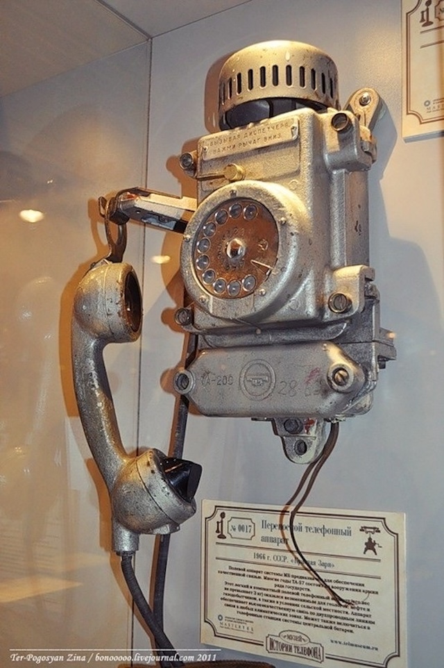 Preserved in a museum, this vintage industrial wall-mounted rotary dial telephone stands as a testament to the engineering marvels of its time