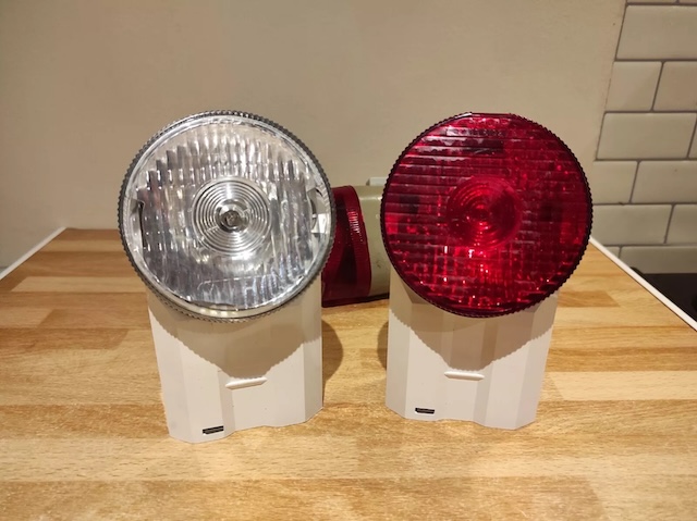 Side-by-side comparison of the vintage front and rear bicycle lights, showcasing their practical and functional design