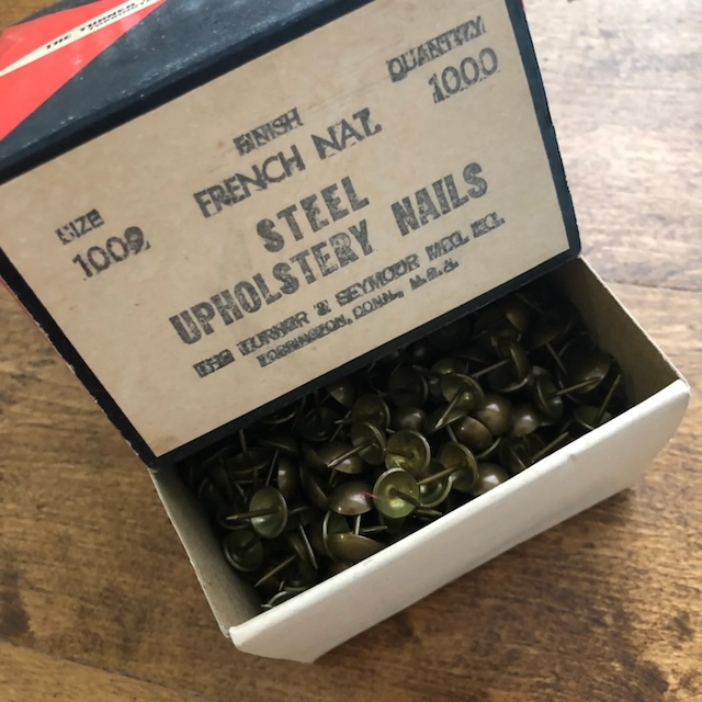 A box of vintage furniture tacks waiting to give new life to a classic piece. Who else appreciates their vintage charm?