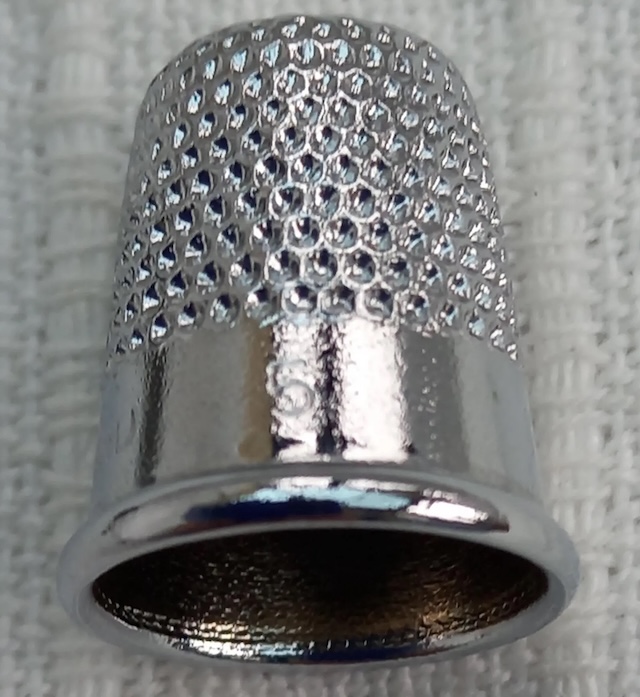 A detailed look at the inside of a vintage thimble, revealing the craftsmanship and precision that went into making these beloved tools