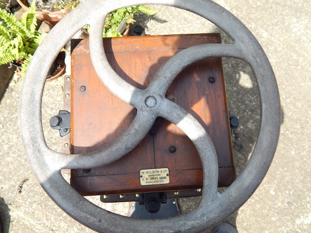 An overhead view focusing on the control wheel, illustrating the manual operation aspect of this Vintage vacuum cleaner designed by David Edward Davies, with visible maker's plaque