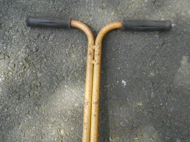 An overhead shot of the vintage reel mower's handlebars, where generations of families have gripped the handles to cultivate their yards