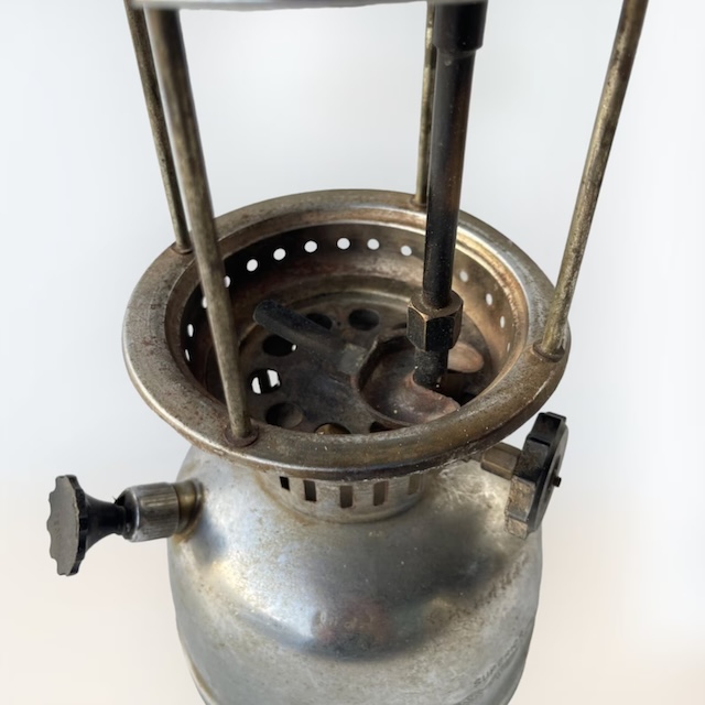 A detailed look at the internal structure of the vintage kerosene pressure lantern, showing the fuel adjustment controls and burner assembly for optimal lighting