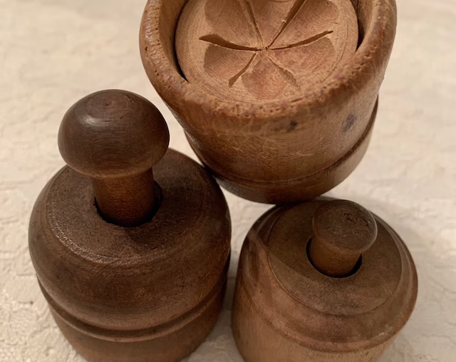 This vintage antique carved wood butter mold shows the history of handmade kitchen items, with intricate carving that reflects a time when kitchen tools were as much about beauty as they were about function.