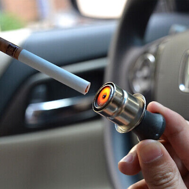 Ready for a quick light on the road! The vintage car cigarette lighter in action, glowing red-hot to ignite with ease