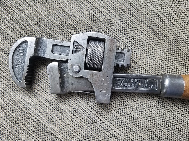 Engraved markings on the wrench's head—a testament to its origin and quality craftsmanship that still resonates with tool collectors