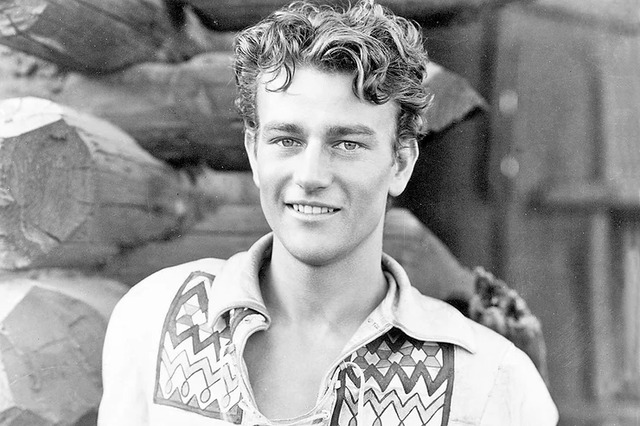 A portrait of a young John Wayne, radiating charm and confidence.