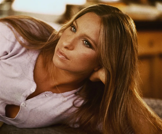 Barbra Streisand showcases her natural charm and poise in this iconic photograph.