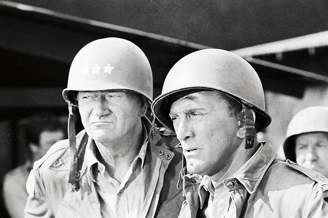 John Wayne alongside Kirk Douglas in a military setting, showcasing his versatility as an actor.