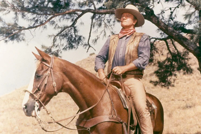 John Wayne in his classic cowboy role, embodying the spirit of the American West.