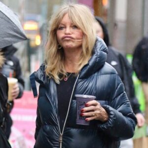 The iconic actress makes a rare appearance in a casual puffer jacket, her transformed look sparking whispers of an unsuccessful facelift.