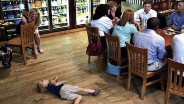 The restaurant scene highlights the child lying down while the mother looks on.