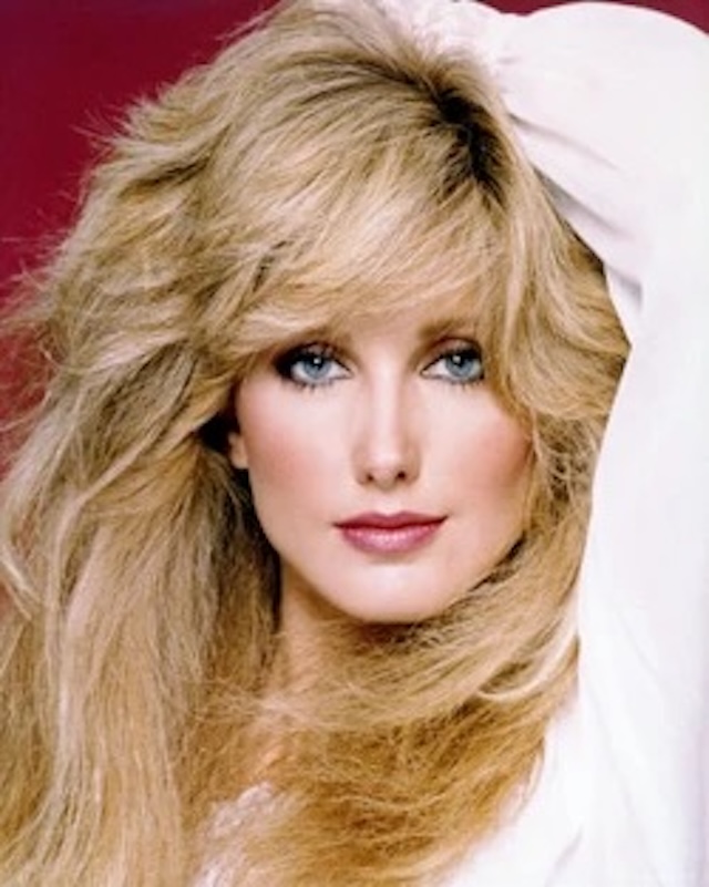 Morgan Fairchild's glamorous look with voluminous hair and piercing eyes captures the essence of 1980s beauty, making her a true fashion and style icon of the era