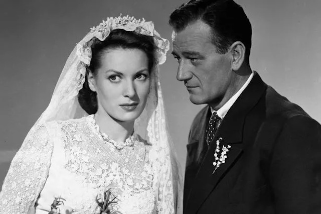 Maureen O’Hara and the legendary John Wayne, captured here in an intimate moment from their famous film, "The Quiet Man." Their onscreen chemistry is still remembered as one of Hollywood’s most iconic pairings