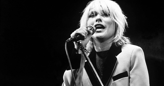 Debbie Harry in action, commanding the stage with her unmistakable voice and edgy fashion, a true punk icon of the '80s