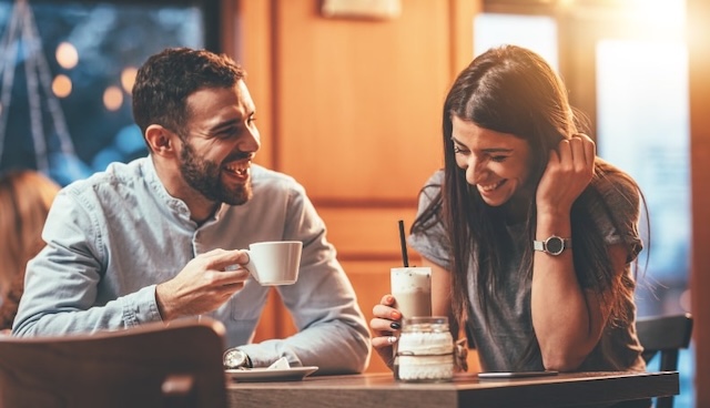 A candid moment capturing a couple enjoying each other's company, showcasing how even the simplest drinks can spark joy and connection