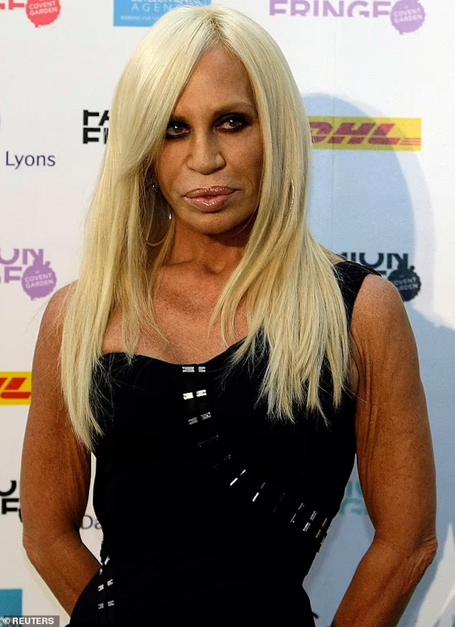 Donatella Versace at a fashion event in a stunning outfit, embracing her glamorous persona