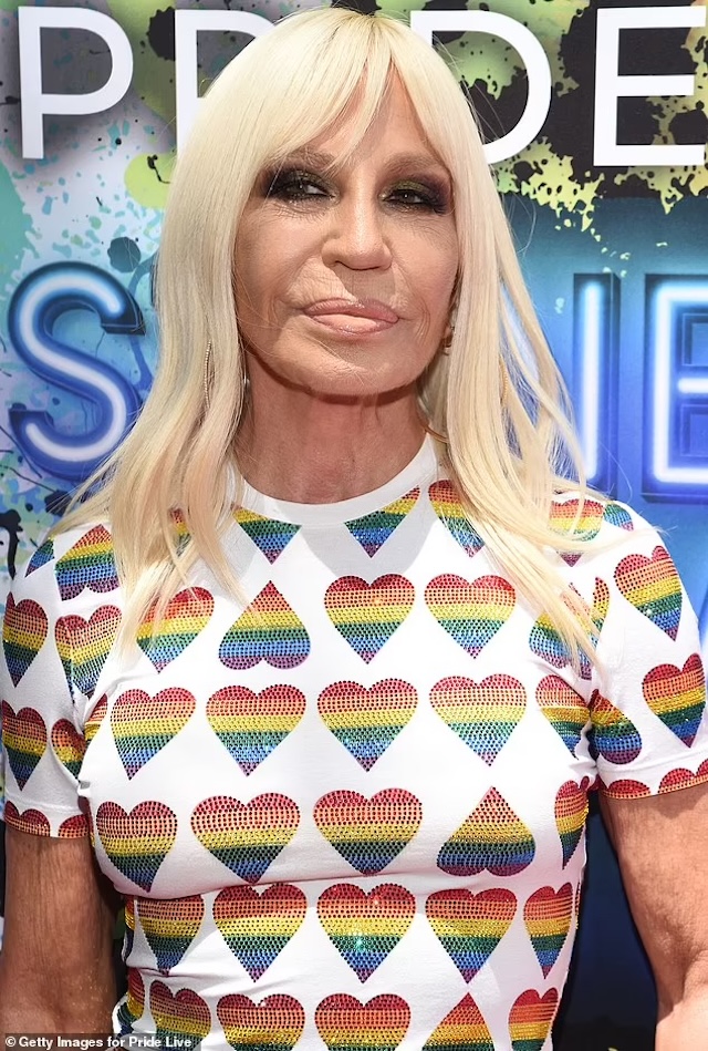 Donatella proudly supports the LGBTQ+ community at a Pride event, wearing a rainbow heart t-shirt that showcases her inclusivity and strong values