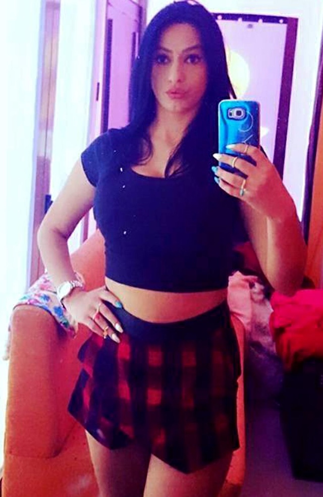 Enki strikes a pose in a fun, playful selfie, showing off her style with a cropped top and skirt. Her confident demeanor both on and off-screen has made her a known name in Albanian media