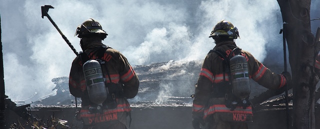 Captured during a critical moment, these firefighters bravely battle a raging fire, working tirelessly to protect lives and property