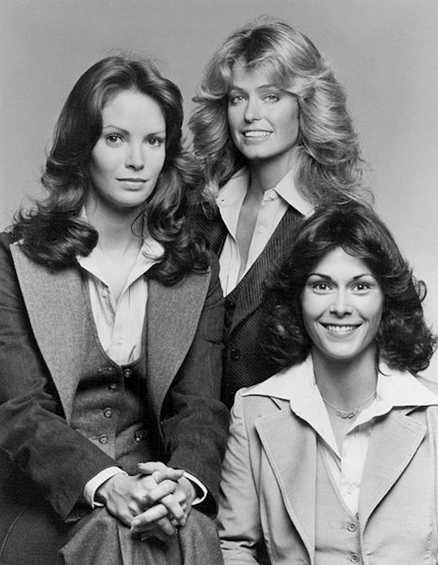 A timeless promotional shot of the original Charlie's Angels cast, where Farrah Fawcett, Kate Jackson, and Jaclyn Smith, in sharp suits, stand as a symbol of strength and independence