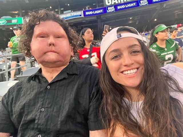 Joe DiMeo and his partner enjoy a day out at a football game, showing his recovery and the bond that has grown stronger over time