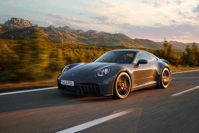 The Porsche 911 GTS cruises down a winding mountain road, blending breathtaking scenery with unmatched performance