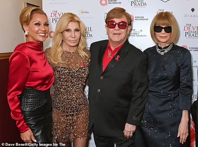 Donatella Versace with friends, including Elton John, Anna Wintour, and others, all gathered for a charitable cause celebrating the film 'The Devil Wears Prada.'